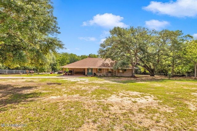 view of yard featuring fence and an attached carport