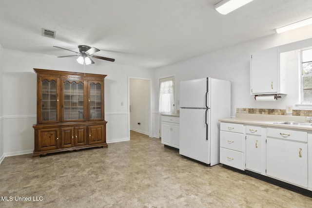 546 Hunters Creek Cir, Madison, MS 39110 - kitchen with freestanding refrigerator, ceiling fan, light countertops, light floors, and white cabinets