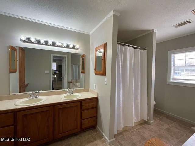 bathroom with crown molding, vanity, a textured ceiling, and toilet