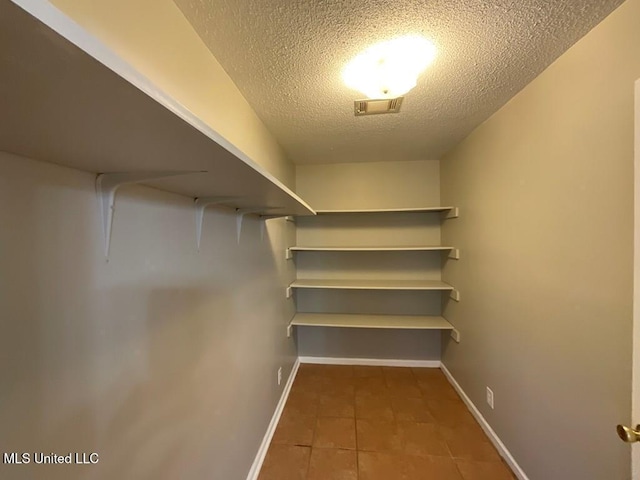 walk in closet featuring tile patterned flooring