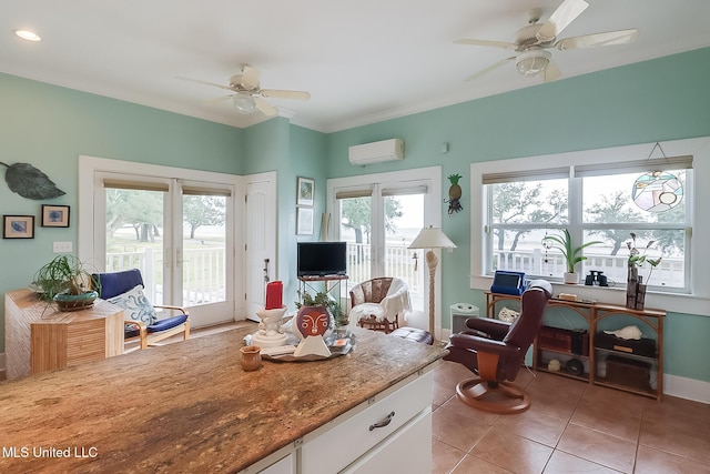 living room with a wall mounted AC, ceiling fan, and light tile patterned floors