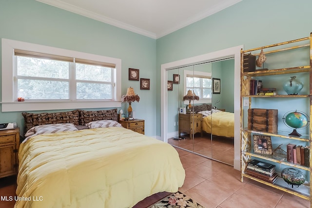 tiled bedroom with a closet and ornamental molding