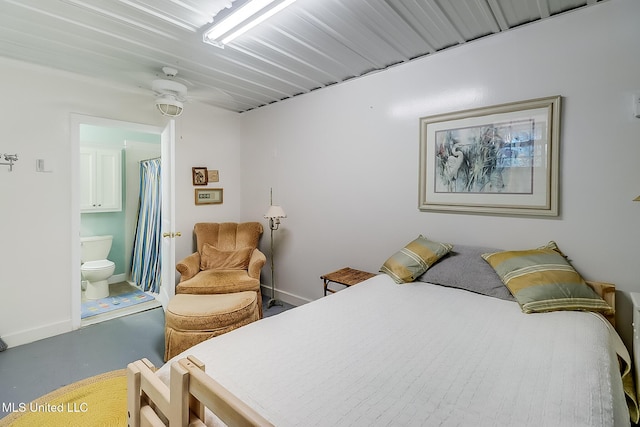 bedroom with concrete flooring, ceiling fan, and connected bathroom