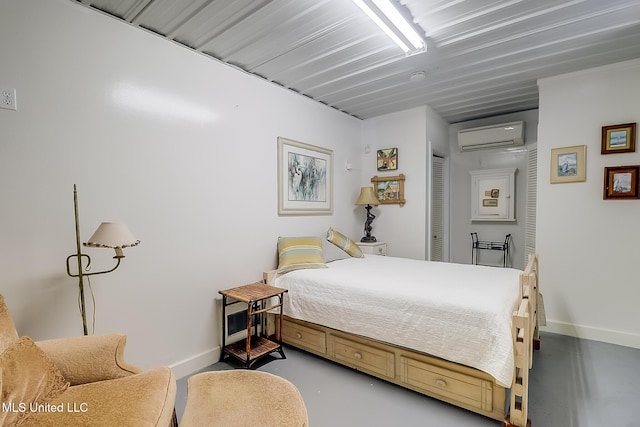 bedroom with concrete floors and a wall mounted air conditioner