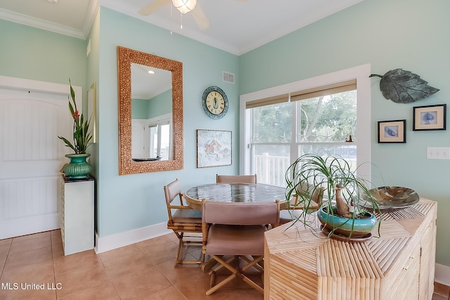 dining room featuring light tile patterned flooring, ceiling fan, a wealth of natural light, and crown molding