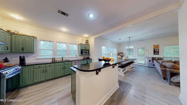 kitchen with visible vents, a sink, appliances with stainless steel finishes, a wealth of natural light, and green cabinets