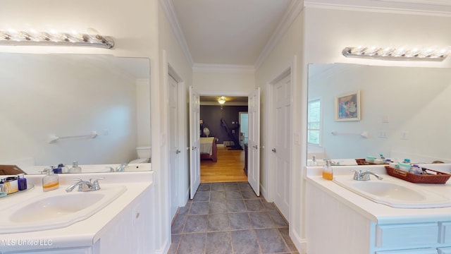ensuite bathroom with vanity, ornamental molding, toilet, and connected bathroom