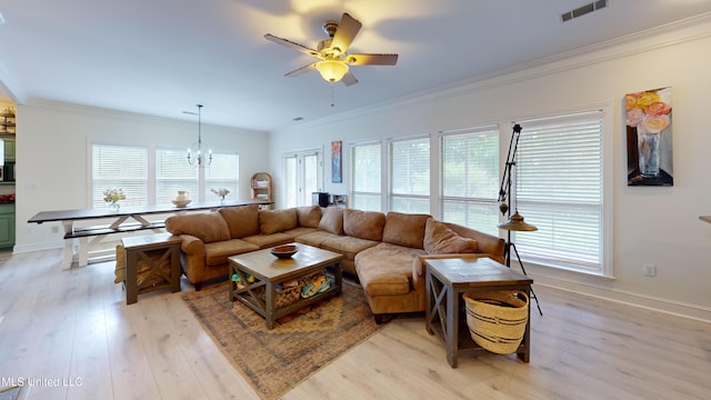 living area featuring visible vents, ornamental molding, light wood finished floors, and ceiling fan with notable chandelier