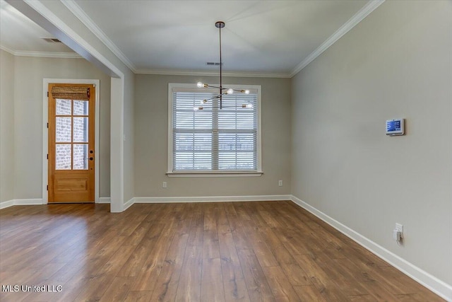 unfurnished dining area with baseboards, ornamental molding, and dark wood finished floors