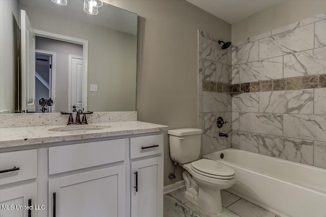 full bath featuring marble finish floor, toilet, washtub / shower combination, vanity, and baseboards