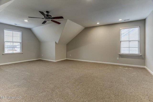 bonus room with lofted ceiling, carpet, visible vents, and a healthy amount of sunlight