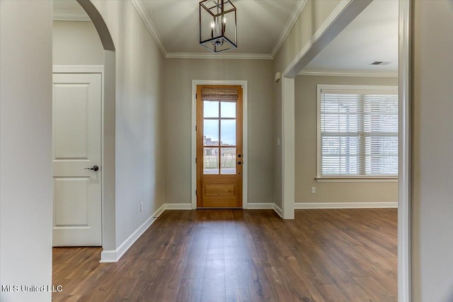 entryway featuring crown molding, arched walkways, wood finished floors, and a healthy amount of sunlight