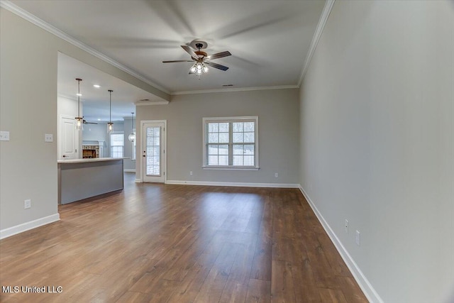 unfurnished living room with ornamental molding, dark wood-style flooring, and a ceiling fan