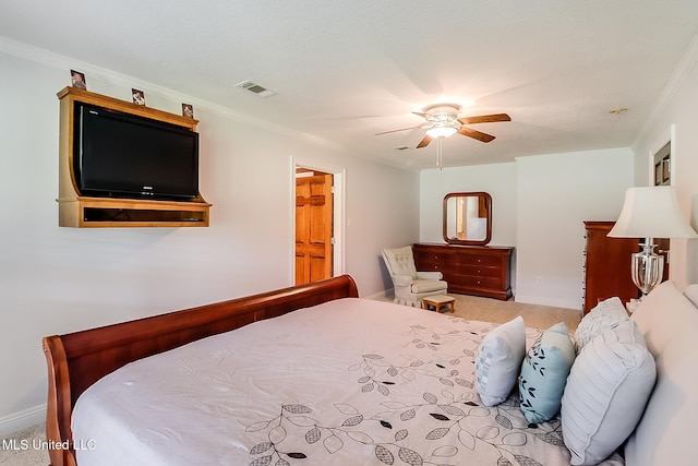 carpeted bedroom featuring crown molding and ceiling fan