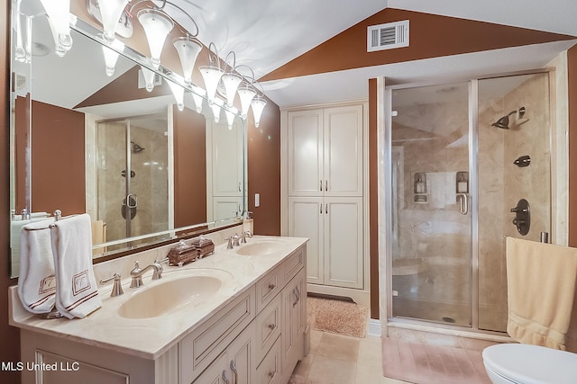 bathroom featuring a shower with door, toilet, lofted ceiling, vanity, and tile patterned flooring