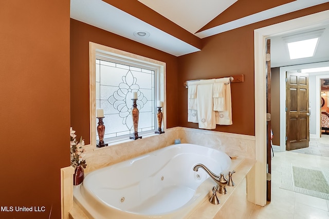 bathroom featuring tiled bath, tile patterned floors, and lofted ceiling