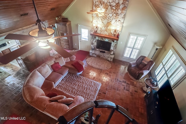 2276 Twin Creek Rd, Lucedale, MS 39452 - living room featuring a stone fireplace, a ceiling fan, high vaulted ceiling, and wooden ceiling