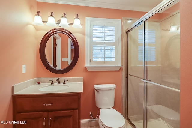 bathroom featuring vanity, toilet, crown molding, and walk in shower