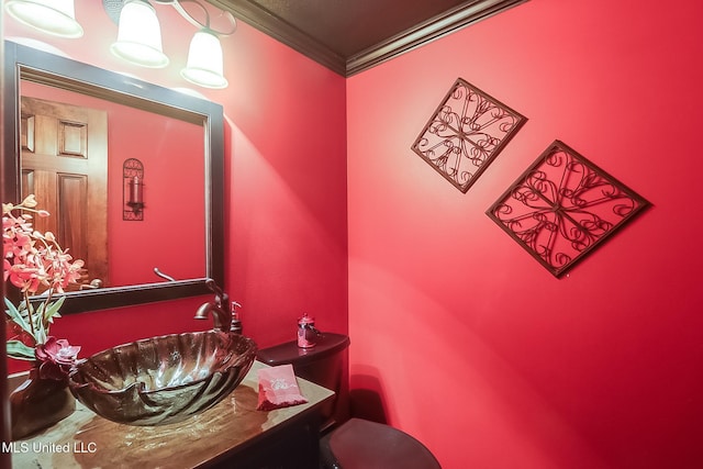 bathroom featuring vanity, ornamental molding, and toilet