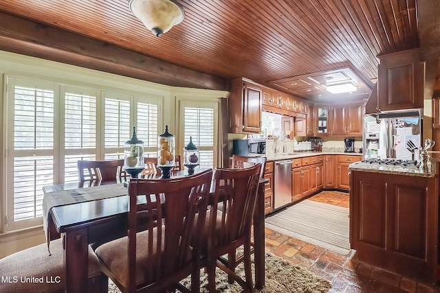 kitchen featuring wood ceiling, stainless steel appliances, and light stone countertops