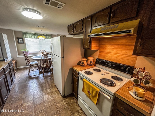 342 Lakebend Dr, Brandon, MS 39042 - kitchen with white appliances, dark brown cabinets, under cabinet range hood, light countertops, and decorative light fixtures