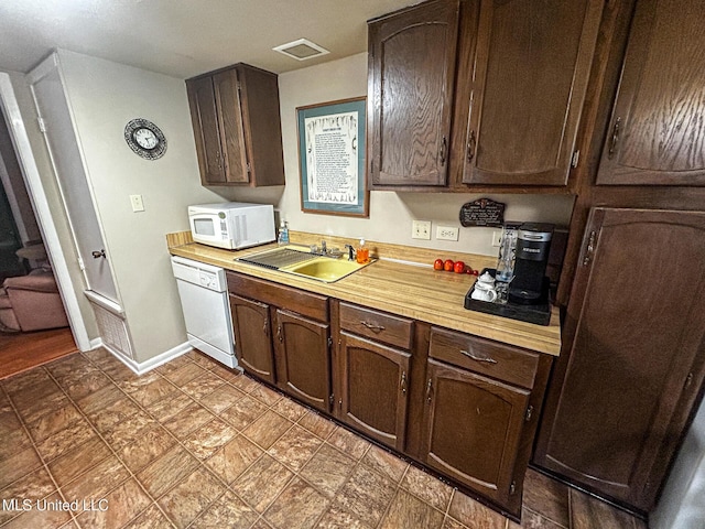 342 Lakebend Dr, Brandon, MS 39042 - kitchen featuring white appliances, a sink, light countertops, and dark brown cabinets