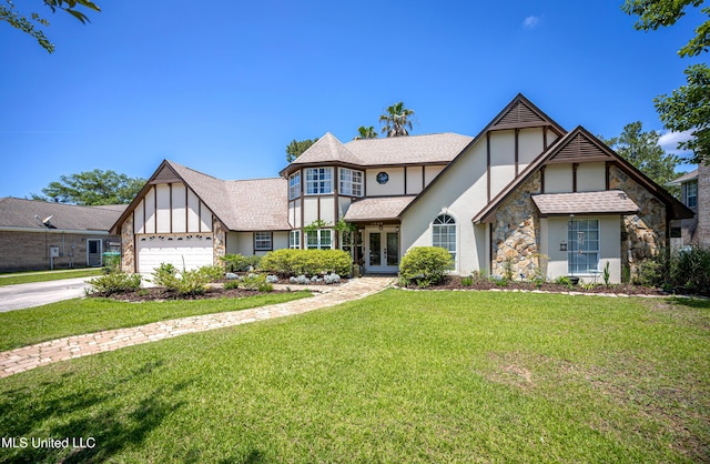 3909 Cabildo Pl, Ocean Springs, MS 39564 - tudor home with french doors, stucco siding, a garage, and a front yard