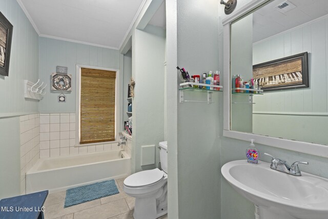 bathroom featuring a tub to relax in, sink, toilet, crown molding, and tile patterned flooring