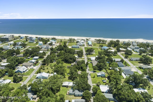 drone / aerial view with a water view and a beach view