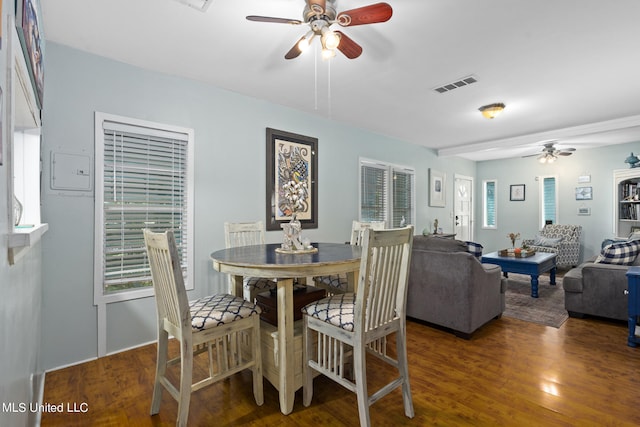 dining space with ceiling fan and dark hardwood / wood-style flooring