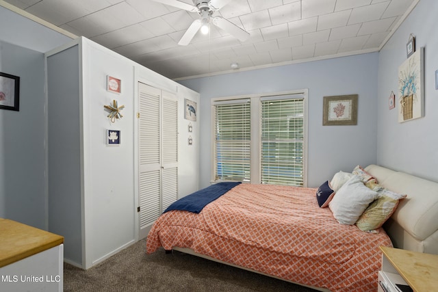 carpeted bedroom featuring a closet, ceiling fan, and crown molding