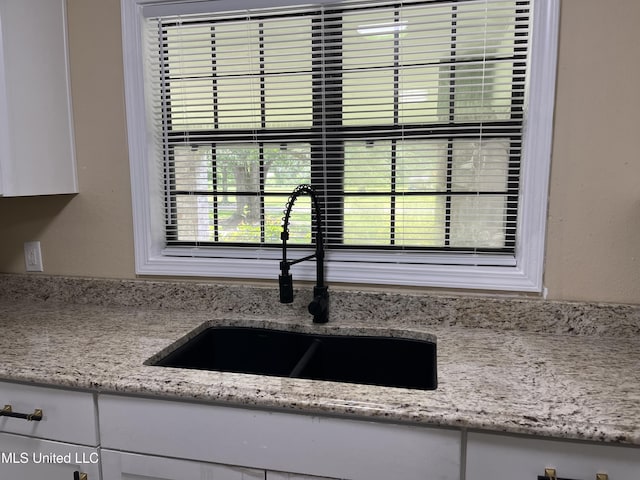 7701 Harold Ave, Moss Point, MS 39563 - kitchen view of white cabinets and light stone counters