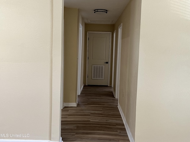 7701 Harold Ave, Moss Point, MS 39563 - corridor featuring dark wood finished floors and baseboards