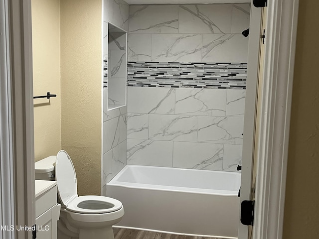 7701 Harold Ave, Moss Point, MS 39563 - full bathroom with vanity, a textured wall,  shower combination, and wood finished floors