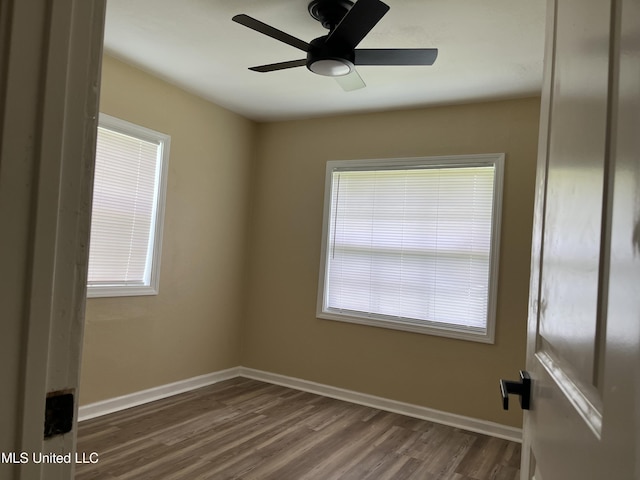 7701 Harold Ave, Moss Point, MS 39563 - spare room featuring dark wood-type flooring and ceiling fan