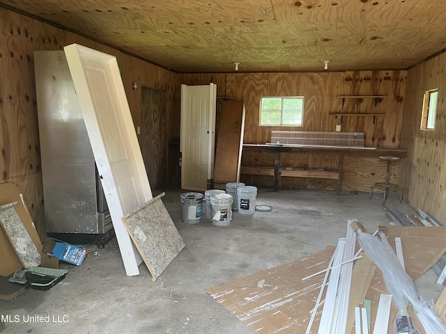 7701 Harold Ave, Moss Point, MS 39563 - miscellaneous room with wood walls and unfinished concrete floors