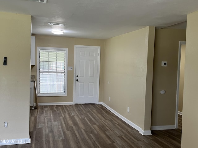 7701 Harold Ave, Moss Point, MS 39563 - foyer featuring dark wood-type flooring and baseboards