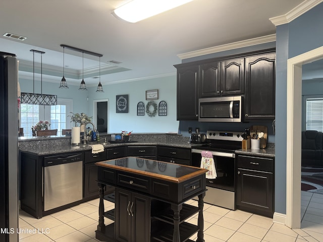 kitchen featuring appliances with stainless steel finishes, light tile patterned floors, a sink, dark cabinetry, and crown molding