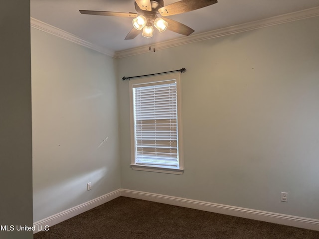 spare room with dark carpet, ceiling fan, baseboards, and ornamental molding