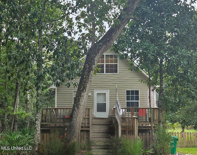 back of property featuring a wooden deck