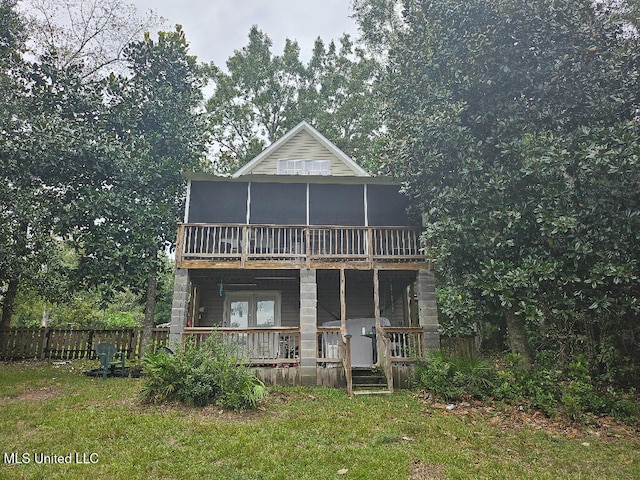 back of house with french doors and a yard