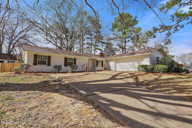 ranch-style house featuring a garage, brick siding, fence, driveway, and a chimney