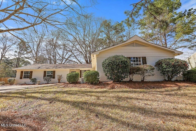 ranch-style house with brick siding and a front yard