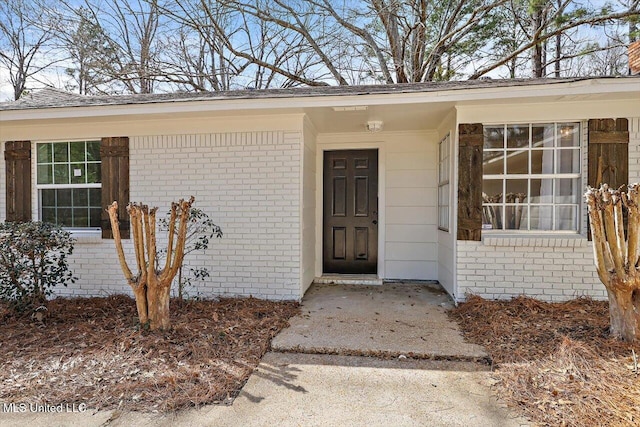 entrance to property with brick siding