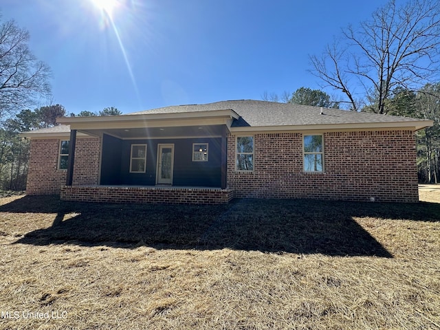 rear view of house with brick siding