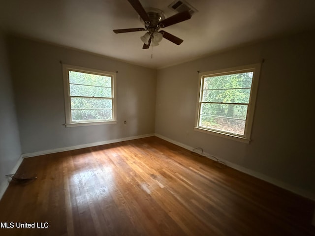 spare room featuring hardwood / wood-style floors, plenty of natural light, and ceiling fan