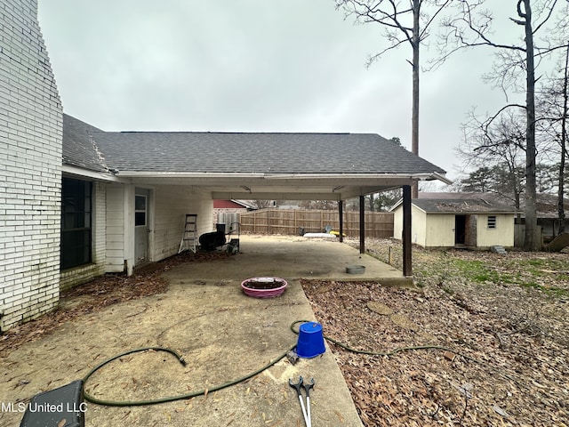 view of yard with a carport and a storage unit