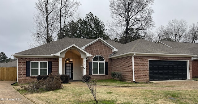 ranch-style home with a garage and a front lawn