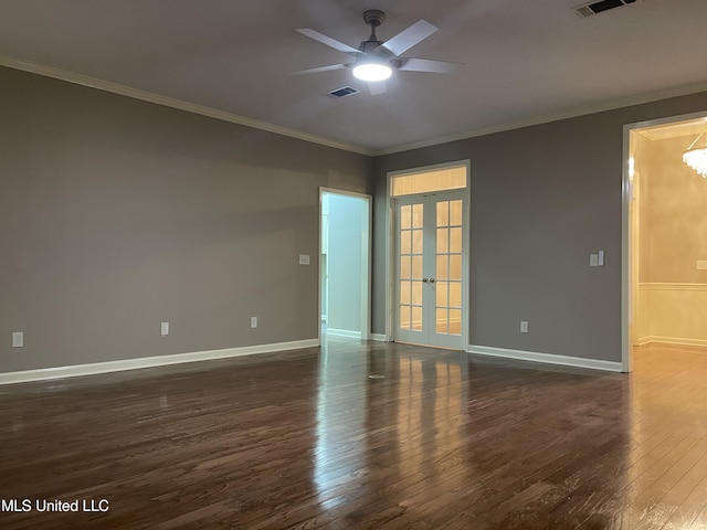 empty room with ceiling fan with notable chandelier, dark hardwood / wood-style flooring, crown molding, and french doors