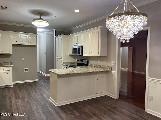 kitchen featuring dark wood-type flooring, white cabinets, crown molding, appliances with stainless steel finishes, and a chandelier